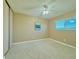 Bright bedroom featuring plush carpeting, a ceiling fan, and natural light at 2118 S Mobile Way, Aurora, CO 80013