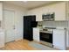 Well-equipped kitchen featuring white cabinets, modern appliances, and light-colored countertops at 2118 S Mobile Way, Aurora, CO 80013
