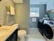 Laundry room features built-in storage and stacked washer and dryer at 2118 S Mobile Way, Aurora, CO 80013
