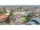 Home aerial view showcasing a spacious, fenced backyard with lush artificial turf and mature landscaping at 6343 Depew St, Arvada, CO 80003