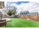 Backyard with artificial turf and a privacy fence, perfect for relaxing or entertaining at 6343 Depew St, Arvada, CO 80003