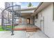 Spacious backyard featuring a wooden deck with spiral staircase and concrete patio at 6343 Depew St, Arvada, CO 80003