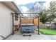 Backyard with a modern hot tub, privacy fence, and low-maintenance landscaping at 6343 Depew St, Arvada, CO 80003