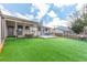 Manicured backyard with artificial turf, covered deck, and hot tub for outdoor fun at 6343 Depew St, Arvada, CO 80003