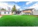Expansive backyard with artificial turf, a hot tub, and a shed for outdoor enjoyment at 6343 Depew St, Arvada, CO 80003