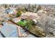 View of the backyard featuring an artificial turf, an outdoor kitchen, and a lovely patio for entertainment at 6343 Depew St, Arvada, CO 80003