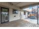 The wooden deck is covered and leads to the backyard with hot tub and spiral staircase at 6343 Depew St, Arvada, CO 80003