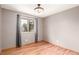 Well-lit bedroom featuring hardwood floors, large window, and a clean aesthetic at 6343 Depew St, Arvada, CO 80003