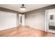 Bright bedroom with hardwood floors, closet space, and en-suite bathroom access at 6343 Depew St, Arvada, CO 80003