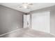 This carpeted bedroom is neutral and features a double-door closet and ceiling fan at 6343 Depew St, Arvada, CO 80003