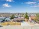 Charming ranch-style home with a well-manicured front yard, a spacious driveway and beautiful mountain view at 6343 Depew St, Arvada, CO 80003