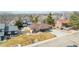 Aerial view of a well-maintained ranch-style home with manicured lawn, long driveway and inviting front porch at 6343 Depew St, Arvada, CO 80003