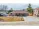 Charming home with a large driveway, manicured front yard, and inviting curb appeal at 6343 Depew St, Arvada, CO 80003