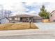 Charming single-story home featuring a well-maintained front yard and attached two-car garage at 6343 Depew St, Arvada, CO 80003