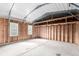 Unfinished detached garage with wooden walls and ceiling with windows on the sides at 6343 Depew St, Arvada, CO 80003