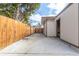 Side yard with concrete pad and wooden privacy fence at 6343 Depew St, Arvada, CO 80003