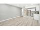 Open living room and kitchen with grey walls and wood flooring at 2707 Valmont Rd # 106B, Boulder, CO 80304