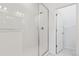 Modern bathroom featuring glass enclosed shower and marble tile flooring at 6912 Huddersfield Ln, Castle Pines, CO 80108