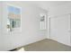 Bright bedroom featuring neutral carpet, closet, and large windows allowing for plenty of natural light at 6912 Huddersfield Ln, Castle Pines, CO 80108