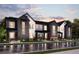 Modern townhome exterior showcasing stylish architecture, dark siding, and well-manicured landscaping at 6912 Huddersfield Ln, Castle Pines, CO 80108