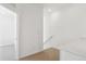 Hallway featuring carpeted stairs, white walls, access to rooms, and white countertops at 6912 Huddersfield Ln, Castle Pines, CO 80108