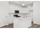 Bright kitchen featuring stainless steel appliances, white cabinets, an island, and hardwood floors at 6912 Huddersfield Ln, Castle Pines, CO 80108