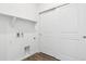 Functional laundry room with built-in shelving and sliding closet doors at 6912 Huddersfield Ln, Castle Pines, CO 80108