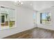 Bright living room with hardwood floors and large windows providing natural light and neighborhood views at 6912 Huddersfield Ln, Castle Pines, CO 80108