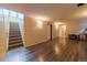 Finished basement with new vinyl flooring, wood paneled walls, and a staircase to the upper level at 3310 W 95Th Ave, Westminster, CO 80031