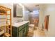 Cozy bathroom with green vanity, sink, toilet, and shower with glass door at 3310 W 95Th Ave, Westminster, CO 80031