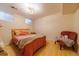 Small bedroom features wood floors, windows, and a peach accent chair at 3310 W 95Th Ave, Westminster, CO 80031