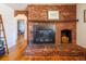 Close-up of brick fireplace with firewood storage and mantle decor at 3310 W 95Th Ave, Westminster, CO 80031