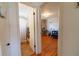 Hallway featuring bathroom on the left and bedroom with hardwood floors on the right at 3310 W 95Th Ave, Westminster, CO 80031