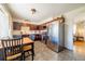 Well-lit eat-in kitchen features dark wood cabinets and stainless-steel appliances at 3310 W 95Th Ave, Westminster, CO 80031