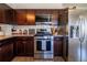 This kitchen features dark wood cabinets, granite countertops and stainless steel appliances at 3310 W 95Th Ave, Westminster, CO 80031