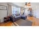 Comfortable living room with hardwood floors, large window, and gray sectional sofa at 3310 W 95Th Ave, Westminster, CO 80031