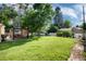 View of the expansive backyard featuring a well-kept lawn, mature trees, and a charming gazebo at 5215 S Washington St, Littleton, CO 80121