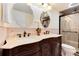 Elegant bathroom featuring dual sinks, decorative mirrors, and a glass-enclosed shower at 5215 S Washington St, Littleton, CO 80121
