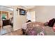 Cozy bedroom with hardwood floors, mounted TV, and doorway to the bathroom at 5215 S Washington St, Littleton, CO 80121