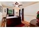 Comfortable bedroom with two windows, ceiling fan, and hardwood floors at 5215 S Washington St, Littleton, CO 80121