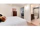 Cozy bedroom featuring access to an ensuite bathroom and a beautiful dresser with floral art at 5215 S Washington St, Littleton, CO 80121