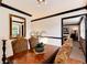 Elegant dining room with a polished wooden table, upholstered chairs, and decorative mirror at 5215 S Washington St, Littleton, CO 80121