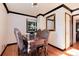 Elegant dining room with wood floors, windows, and an ornate dining set at 5215 S Washington St, Littleton, CO 80121
