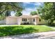 Attractive single-level home with a well-manicured lawn and an attached garage on a sunny day at 5215 S Washington St, Littleton, CO 80121