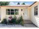 Inviting front entrance with charming seating area amidst colorful garden, offering a warm welcome at 5215 S Washington St, Littleton, CO 80121
