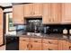 Well-maintained kitchen features wood cabinets, granite countertops, stainless appliances and black accents at 5215 S Washington St, Littleton, CO 80121