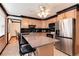 Well-lit kitchen featuring granite countertops, stainless steel appliances, and a central island with seating at 5215 S Washington St, Littleton, CO 80121
