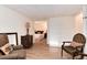 Spacious living room that flows into a bedroom with comfortable furnishings at 5215 S Washington St, Littleton, CO 80121