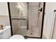 Bathroom with luxurious tiled shower, glass doors, and bronze hardware at 5215 S Washington St, Littleton, CO 80121