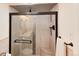 Bathroom with luxurious tiled shower, glass doors, and bronze hardware at 5215 S Washington St, Littleton, CO 80121